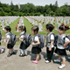Kindergarten pupils walk past gravestones of soldiers who died in the 1950-1953 Korean War during a visit to Seoul’s National Cemetery.